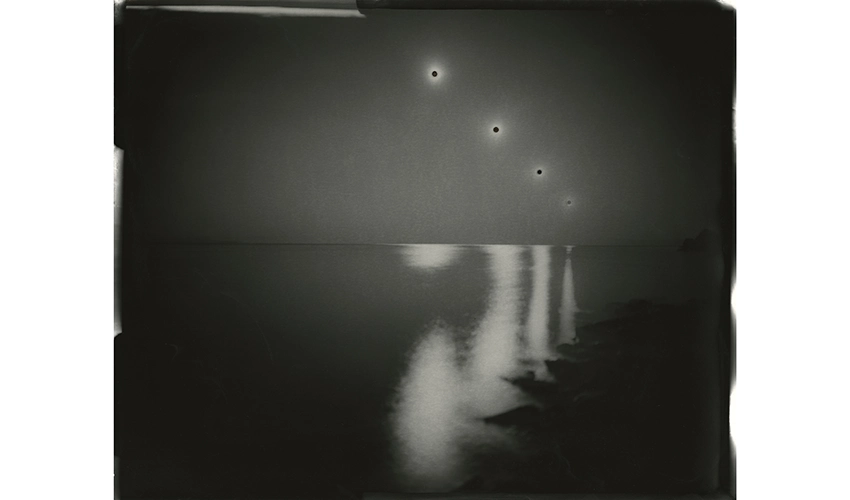 black and white photo of reflections in a body of water receding into the horizon